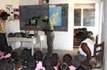 Hery, our Malagasy guide, Presenting a slide show on wildlife conservation with the school principal & his wife looking on, Fitiavana School, Mangily, Ifaty